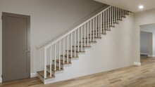 Straight Staircase With Railings In An Empty Room. 3d Render