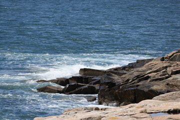 Wall Mural - Ocean waves crashing on a rocky shore