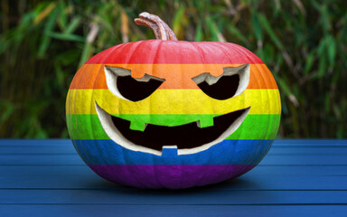 Traditional American jack-o'-lantern in the colors of the Rainbow flag, symbol of lesbian, gay, bisexual, and transgender (LGBT) pride. Gay Halloween celebration.