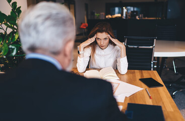 Wall Mural - Annoyed businesswoman working in office with male colleague