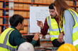 © Tongpool - Group of worker in the warehouse factory conduct toolbox talk daily meeting and argument brainstorm in the morning before start working