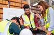 © Tongpool - Group of worker in the warehouse factory conduct toolbox talk daily meeting and argument brainstorm in the morning before start working