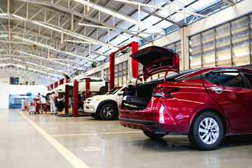 Wall Mural - car in automobile repair service center with soft-focus and over light in the background