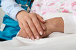 Nurse holding senior woman hand