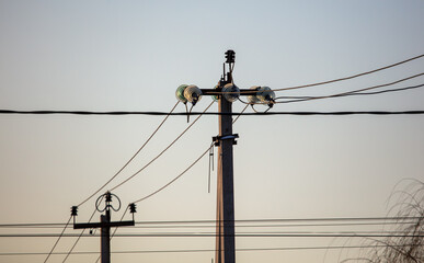 Electric pole on the background of the sunset. Technology