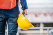 © Suriyo - Safety hard hat concept,Engineer holding hard hat construction worker professional safety work industry building person manager service, Safety hard hat construction