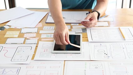 UX UI Concept, Graphic designers work together with UX UI designer planning application template layout framework for mobile phone computer mobile
