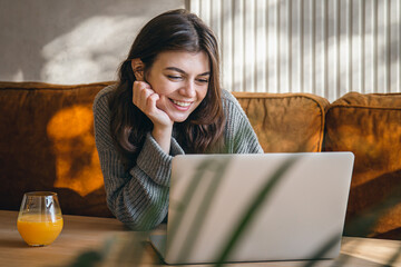 Attractive young woman working on a laptop early in the morning.