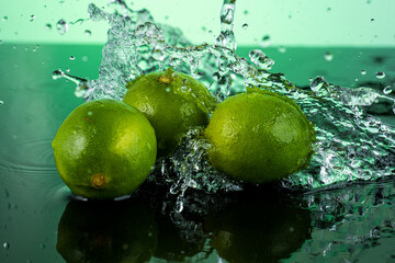 Wall Mural - three whole limes on dark glass with reflection