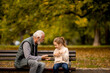 © BGStock72 - Grandfather playing red hands slapping game with his granddaughter in park on autumn day