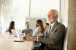© BGStock72 - Senior business man working on digital tablet in the office