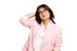 Young Indian business woman wearing a pink suit isolated touching back of head, thinking and making a choice.
