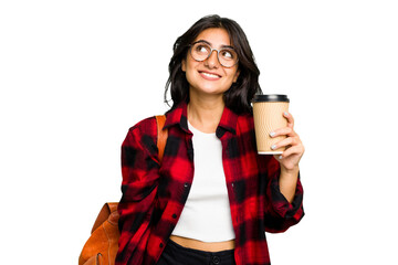 Wall Mural - Young student Indian woman holding a take away coffee isolated dreaming of achieving goals and purposes