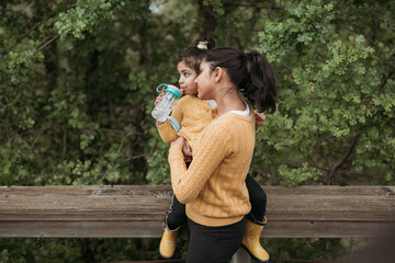 Wall Mural - Older sister with younger sister at a trail 