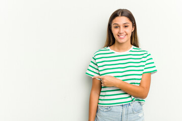 Young Indian woman isolated on white background smiling and pointing aside, showing something at blank space.