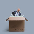 Businessman with back pain in a delivery box