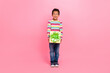Full size photo of impressed staring boy striped long sleeve jeans holding unbelievable unexpected gift isolated on pink color background