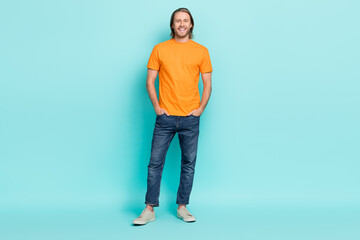 Sticker - Full length photo of attractive charming guy dressed orange t-shirt smiling walking isolated teal color background