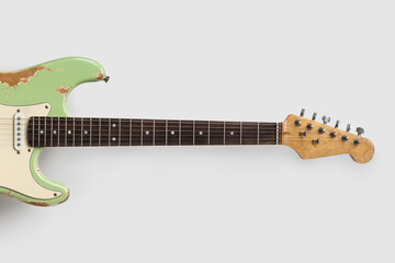 Wall Mural - Old green guitar on white background. Vintage music wallpaper