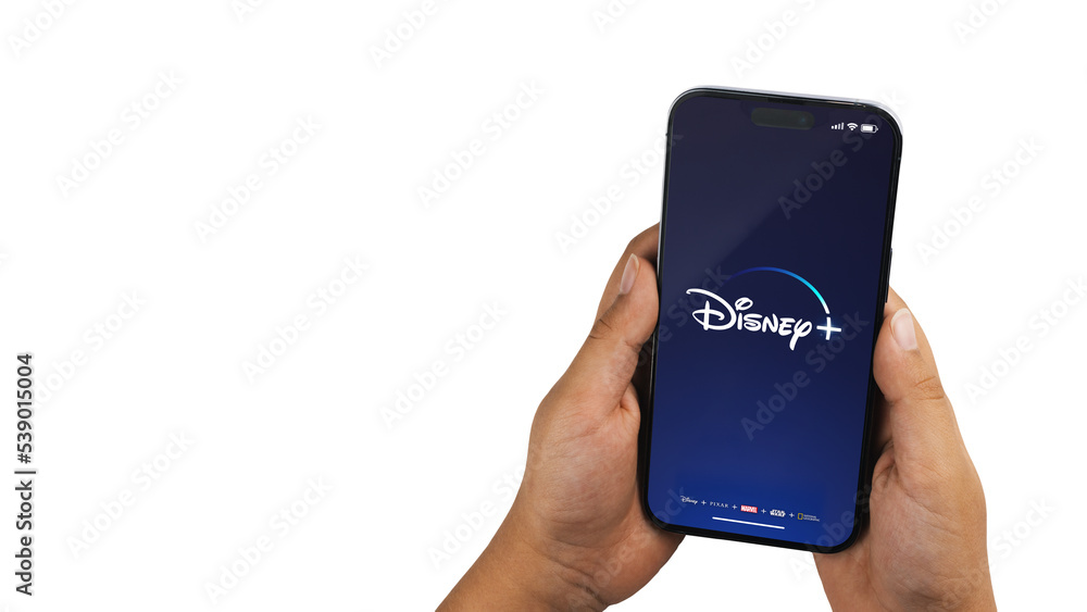 Boy holding a smartphone iPhone 14 Pro with Disney+ (Disney Plus ...