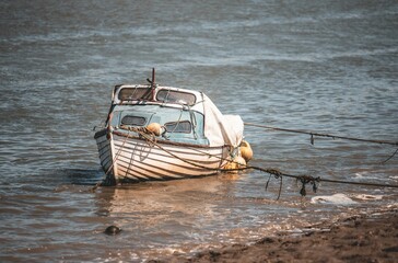 Sticker - Single boat on the water surface near the beach on a sunny day