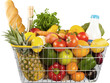 Shopping cart full with various groceries on  background