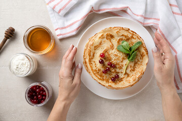 Wall Mural - Stack of homemade pancakes served with honey and berries, top view