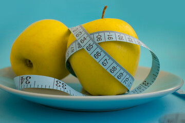 Wall Mural - Apple measuring tape on colored background