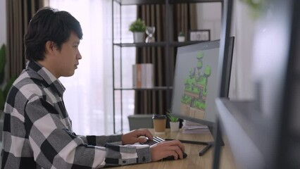 Male developer design 3d game at his office. He using 3d sofware to design game.