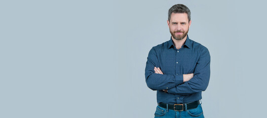 Confident man wear fashion shirt with casual jeans keeping arms crossed grey background, confidence. Man face portrait, banner with copy space.