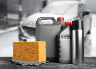 Wall Mural - Cleaning supplies on black stone surface at car wash