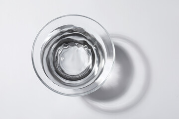Wall Mural - Glass bowl with water on white background, top view