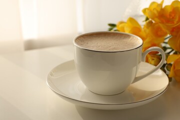 Wall Mural - Delicious morning coffee and flowers on white table indoors, space for text