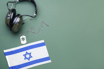 Wall Mural - Military tag, headphones and national flag of Israel on green background