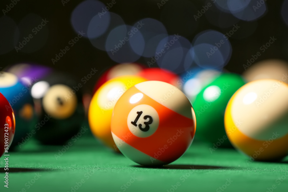 Colorful billiard balls on table, closeup