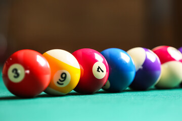 Wall Mural - Colorful billiard balls on table, closeup