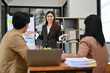 © bongkarn - Asian female financial analyst presenting her financial strategy to board members in the meeting