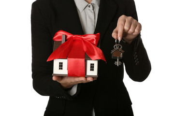 Poster - Real estate agent with house model and key on white background, closeup