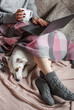 © Olena Rudo - Cozy home, woman covered with warm blanket, drinks coffee,  sleeping dog next to woman.