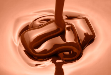 melted chocolate as it is poured to make a pastry dessert
