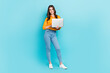 © deagreez - Full body portrait of gorgeous cheerful lady hold wireless netbook isolated on blue color background