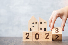 Hand Flip 2022 To 2023 Block With House Model. Real Estate, Home Loan, Tax, Investment, Financial, Savings And New Year Resolution Concepts