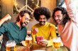 © Xavier Lorenzo - Three excited multiracial friends celebrating victory and winning online bet on match using betting online sport app on mobile phone