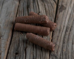 Poster - Close-up of chocolate sticks on a wooden table