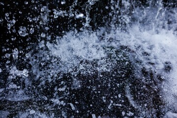 Flow of clean water in the waterfall, close-up, background