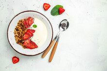Granola With Yogurt With Fresh Strawberry, Chia Seeds And Honey On A White Background. Delicious Balanced Food Concept. Banner, Menu, Recipe Place For Text, Top View