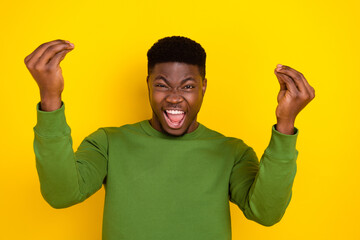 Wall Mural - Portrait of attractive cheerful crazy guy having fun lottery winner isolated on bright yellow color background