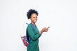 © wazkkii - Close up portrait of cheerful african american woman standing on white background with smart phone