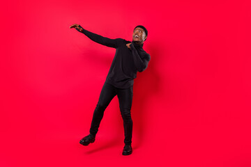 Wall Mural - Full length body size view of attractive cheerful funny guy dancing moving having fun isolated over bright red color background