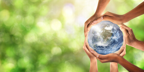 conceptual symbol of multiracial human hands surrounding the earth globe. unity, world peace, humani